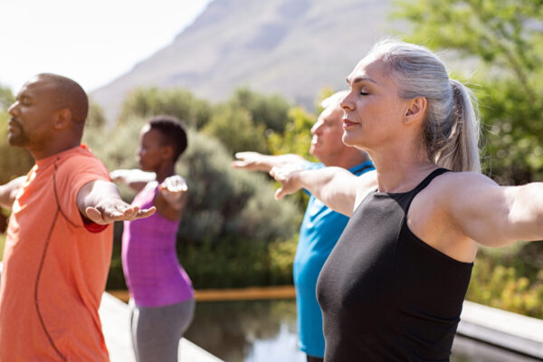 Mature group of people doing breathing exercise