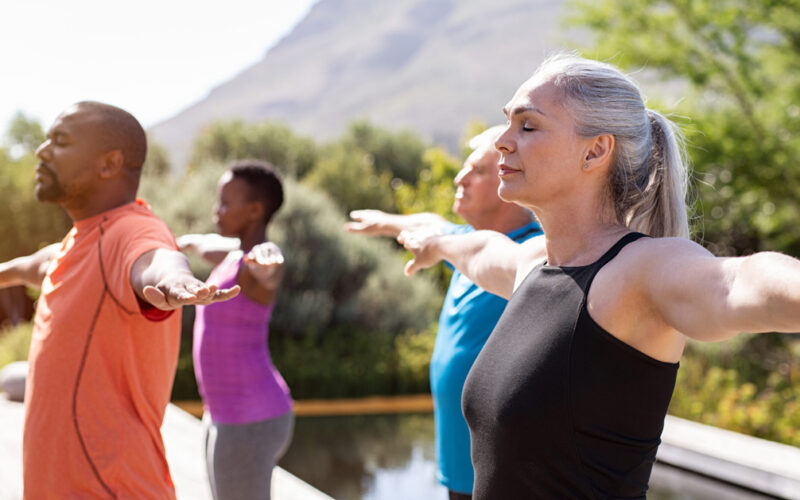 Mature group of people doing breathing exercise