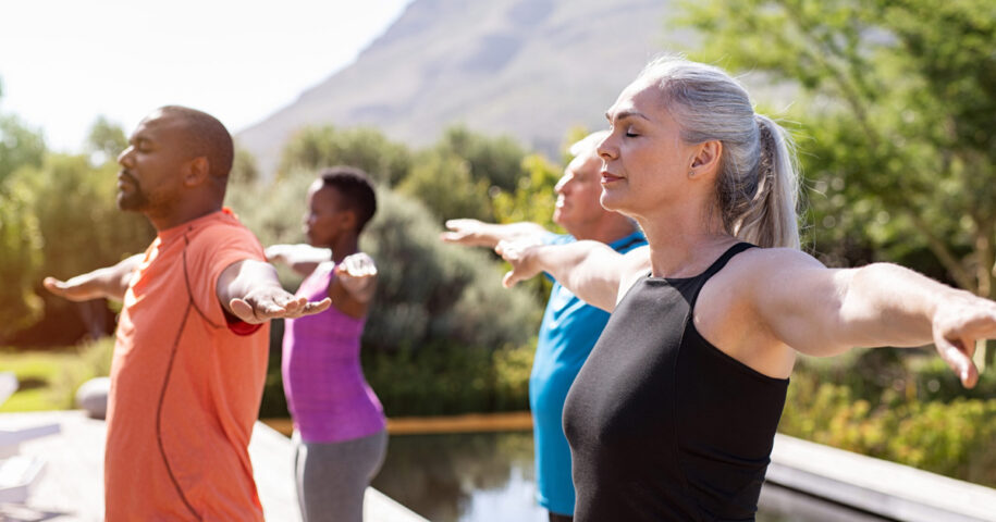 Mature group of people doing breathing exercise